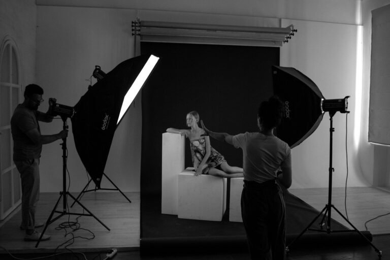 a man taking a picture of a woman in a bed