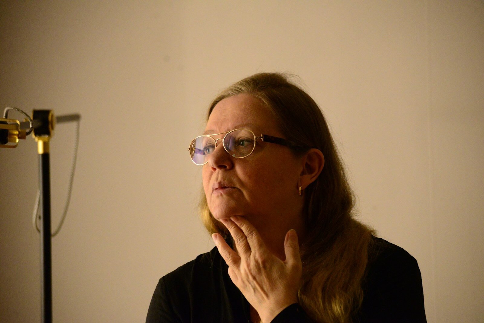 woman in black long sleeve shirt wearing eyeglasses