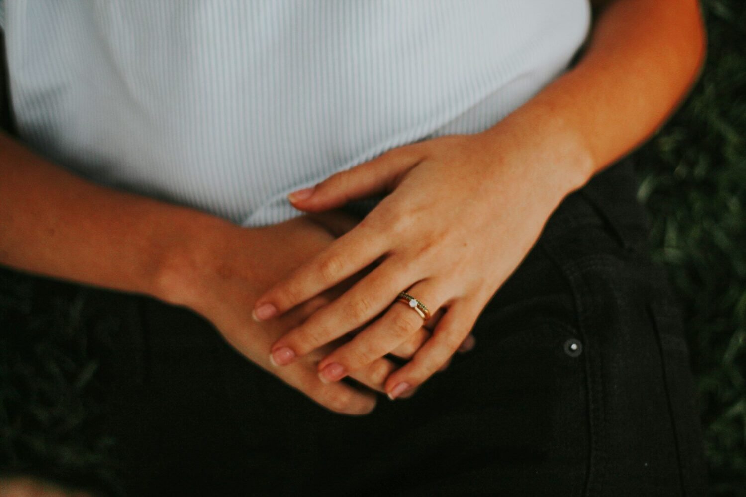 person wearing silver ring and white shirt